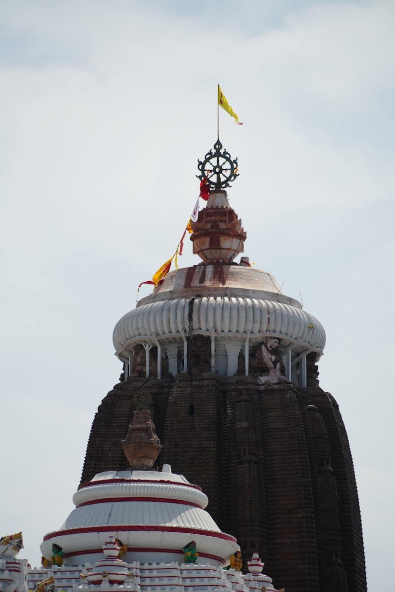 A striking view of Jagannath Temple's spire in Puri, Odisha, showcasing intricate architecture.